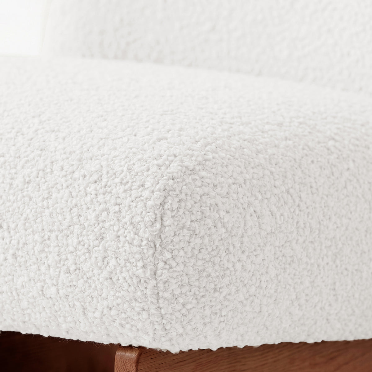 Close-up of seat cushion texture and wooden base.