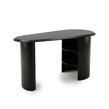 Sleek black desk with asymmetrical oval top and built-in shelving on a white background