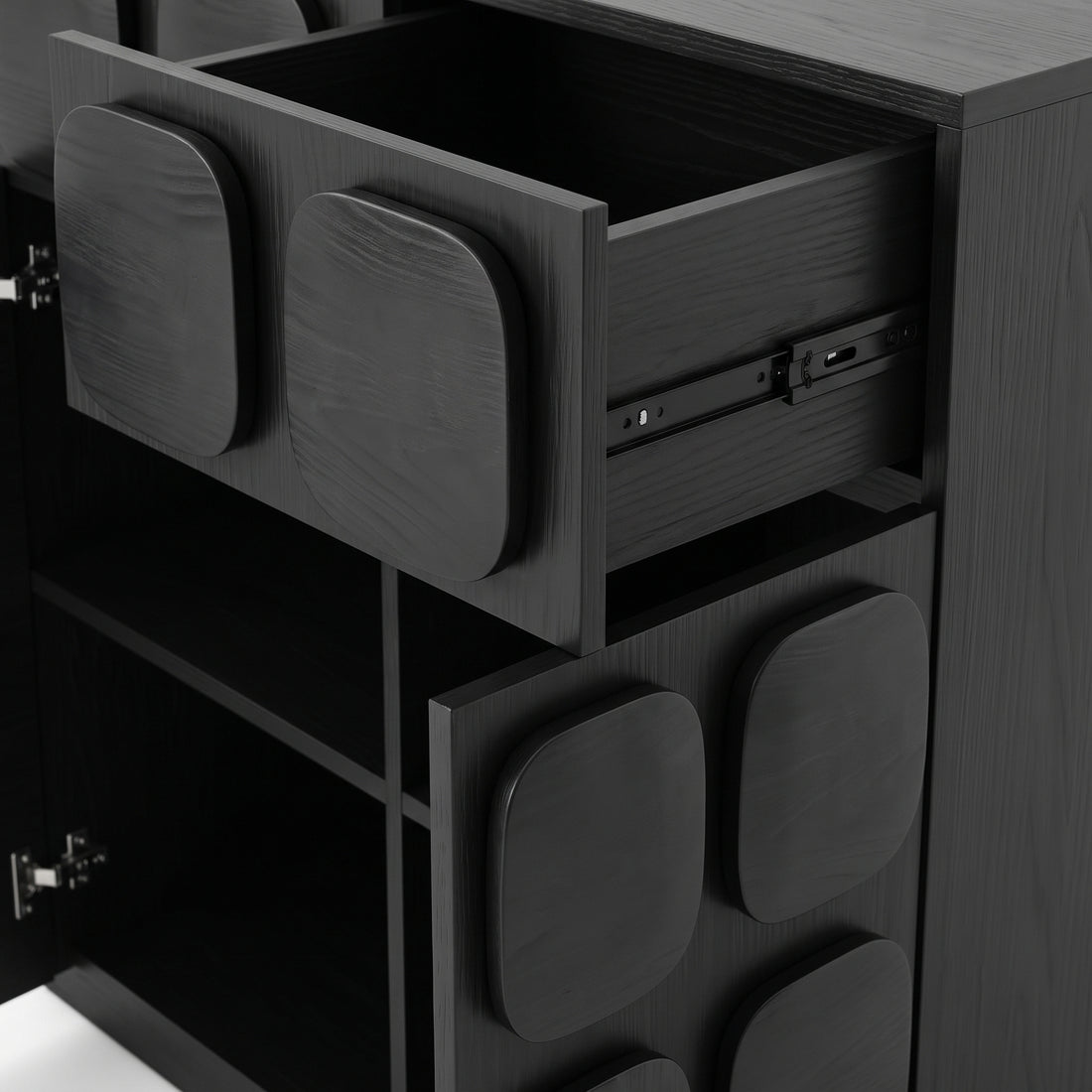 Close-up of a black cabinet drawer section with one drawer open