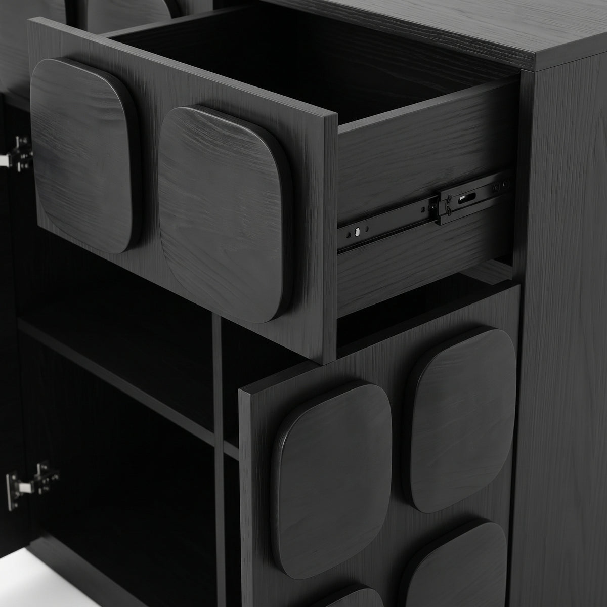 Close-up of a black cabinet drawer section with one drawer open