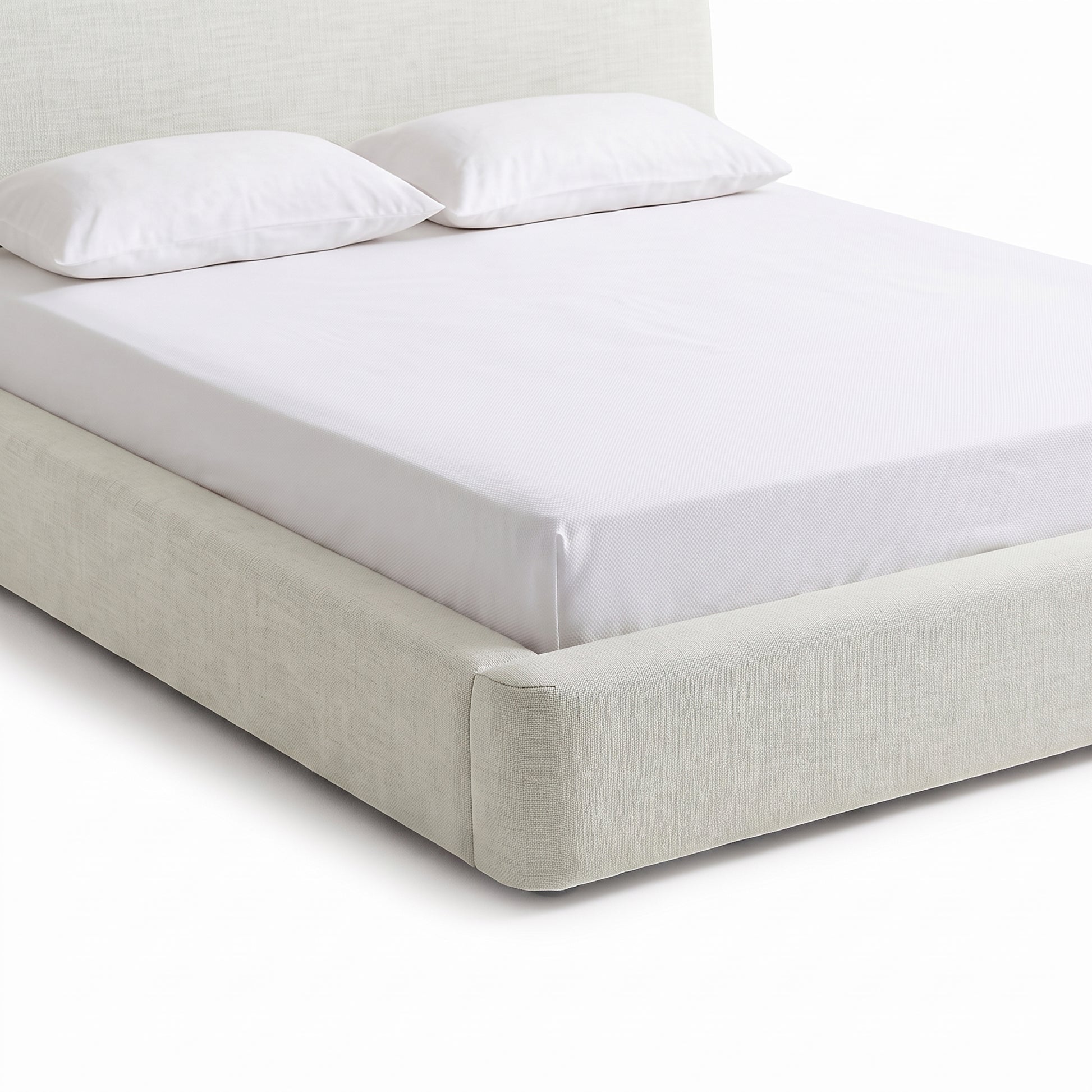 Partial view of an upholstered bed and headboard on a white background