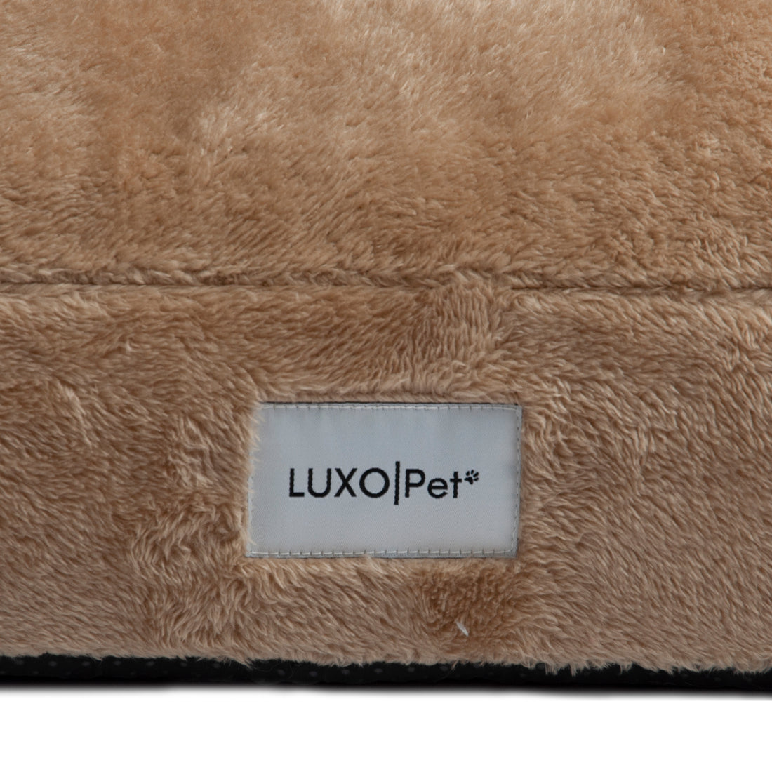 Macro view of beige plush material with LUXO|Pet label