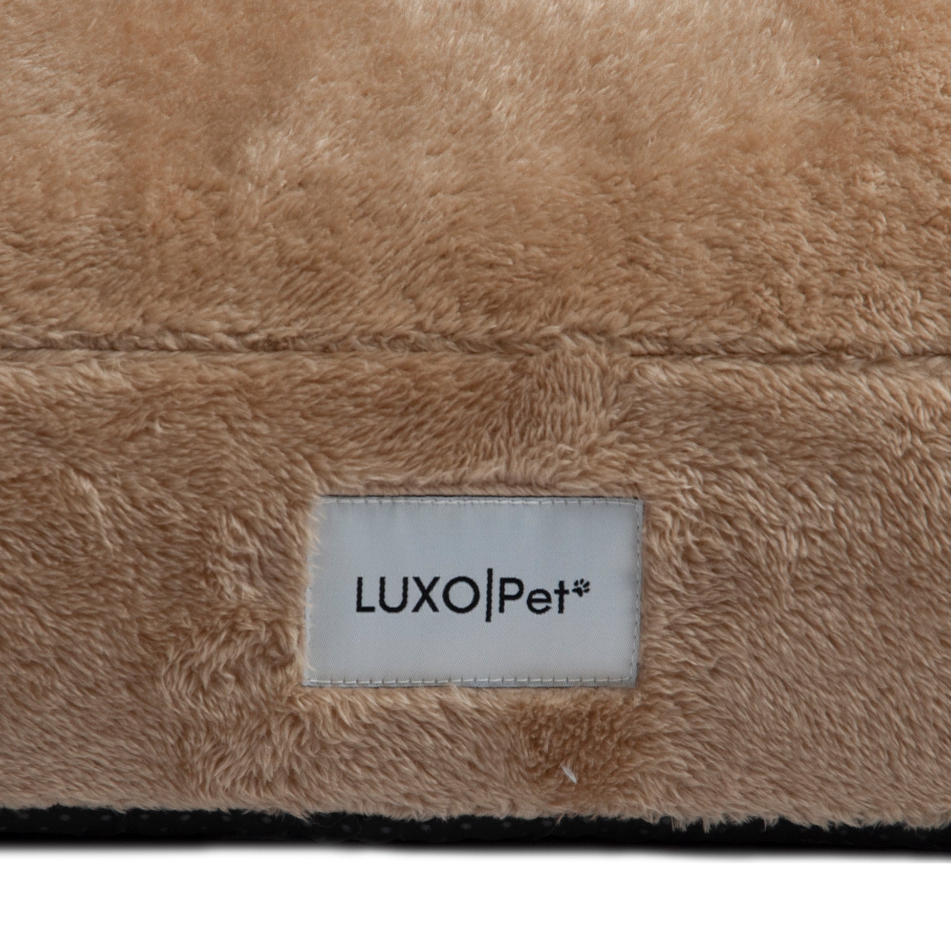 Macro view of beige plush material with LUXO|Pet label