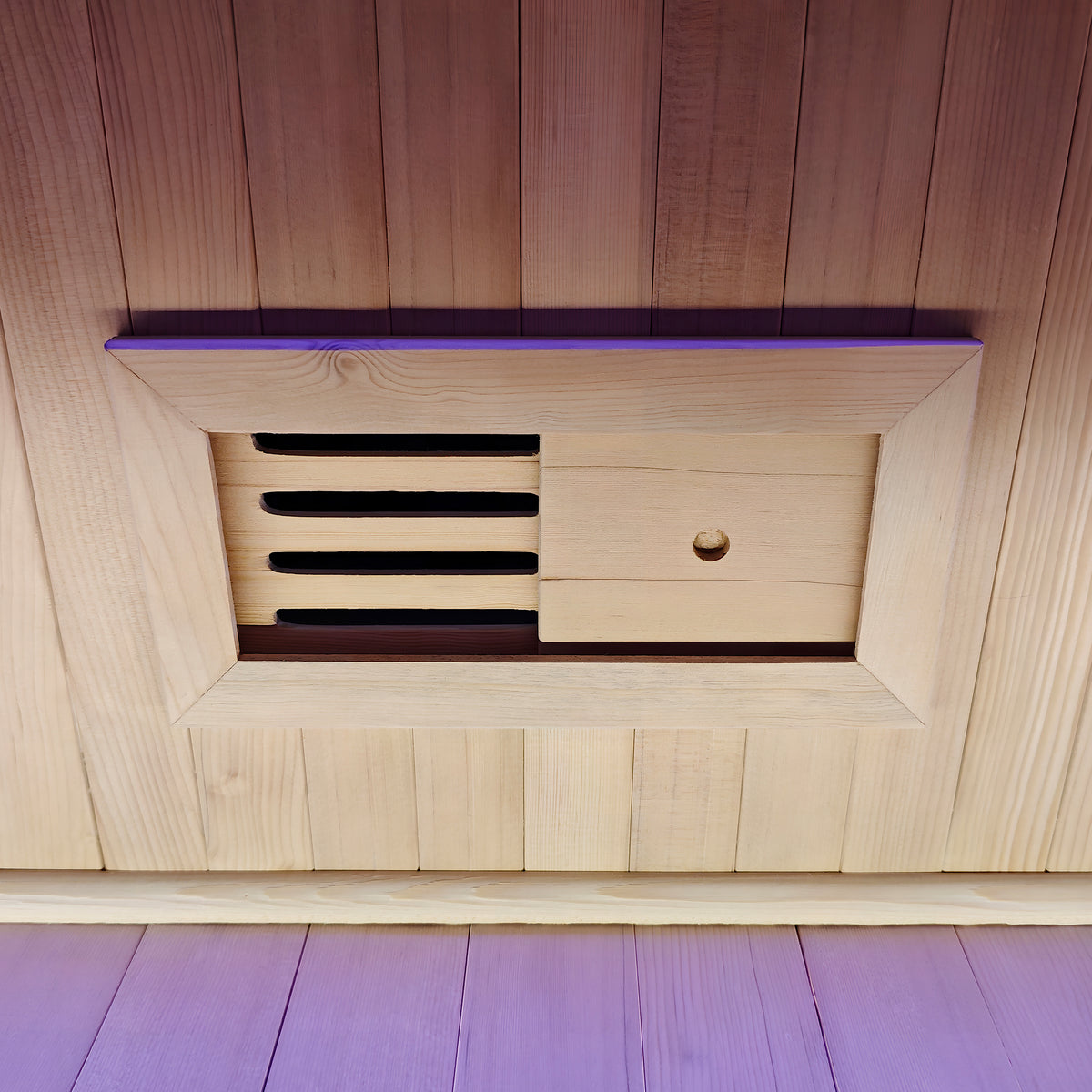 Close-up of a wooden adjustable vent panel in a sauna wall