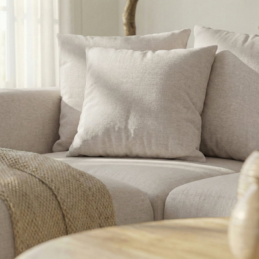Close-up of sofa corner with pillows and throw in a living room