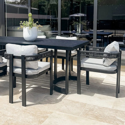 Modern outdoor dining set with table and four chairs on a patio