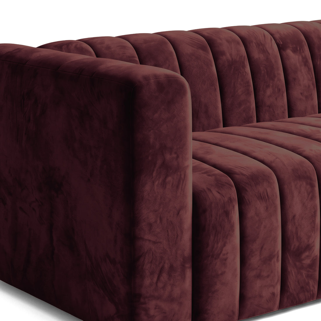 Close-up of a burgundy sofa arm and cushions on a white background