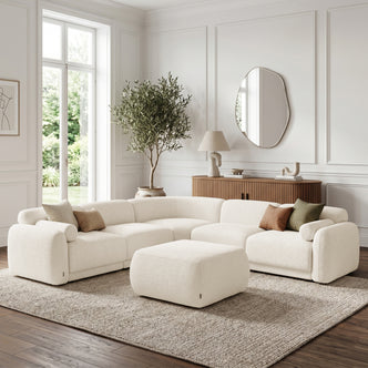 Modular sectional sofa with ottoman in a bright styled living room