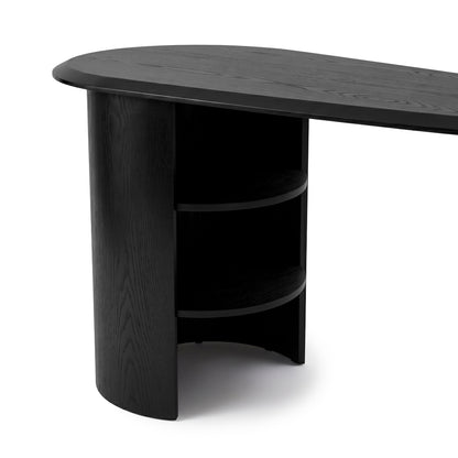 Black desk with oval top and shelving on a white background