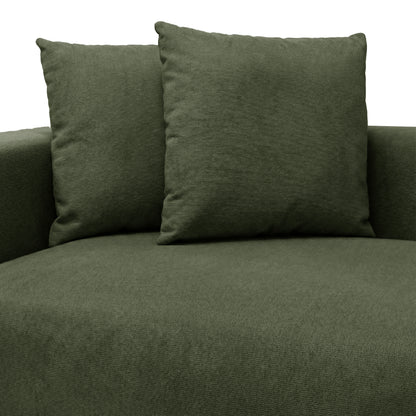 Partial view of green sofa seat and back cushions on white background