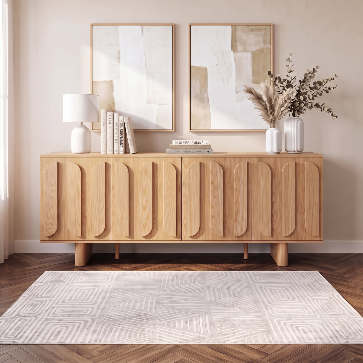 Wooden sideboard styled in a modern living space with books, lamp, vase, and wall art
