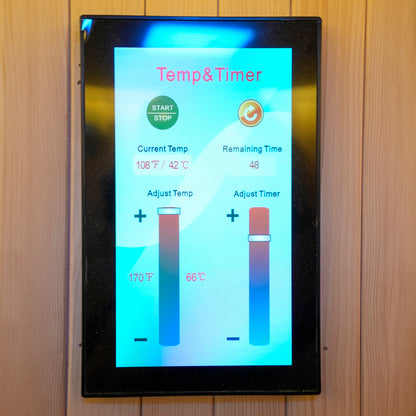 Touchscreen sauna control panel mounted on a wooden wall