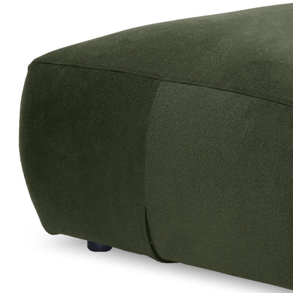 Close-up of green ottoman corner showing fabric texture