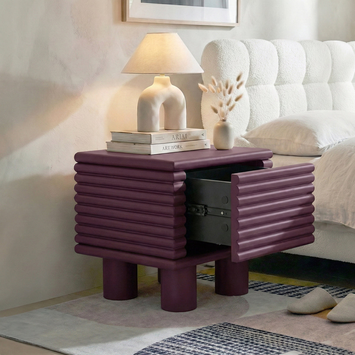 Burgundy ribbed nightstand in bedroom with open drawer