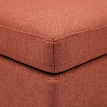 Close-up of terracotta upholstered cushion corner and piping