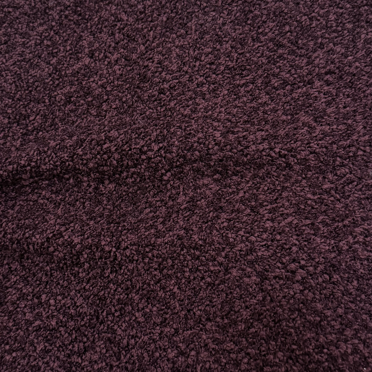 Close-up of plum textured fabric upholstery