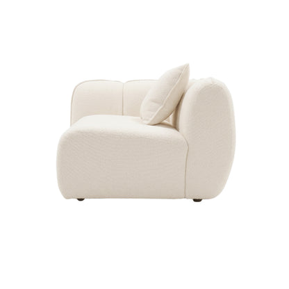 Side view of a cream upholstered sectional sofa section on white background