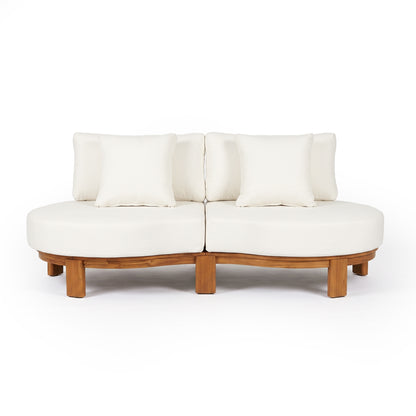 Modern two-piece curved sofa with wooden base and white pillows on a white background.