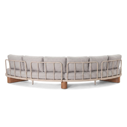 Rear view of a curved sectional sofa with wooden slat frame on a white background.