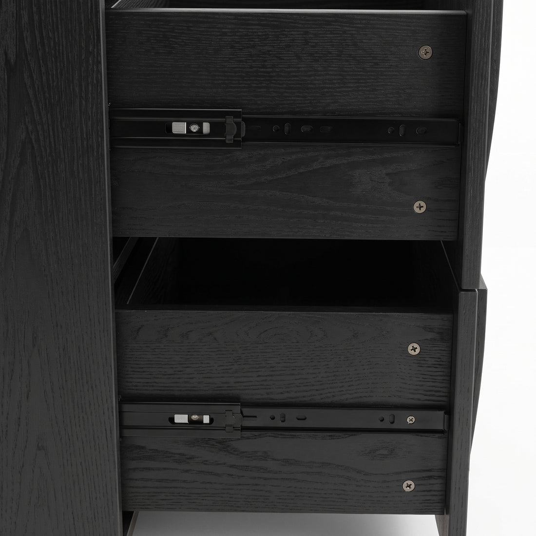 Close-up side view of a black wood cabinet with partially open drawers