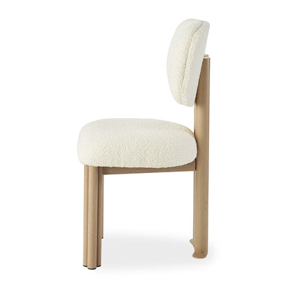 Norii Boucle Fabric Dining Chair in Cream White, showcasing a light-wood frame with cylindrical legs and a gently curved, off-white bouclé upholstered seat and back pad for modern elegance.