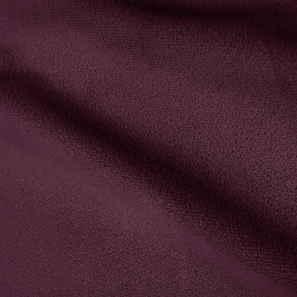 Close-up texture of plum velvet upholstery