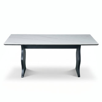 Full rectangular table with light marble-look top and dark sculptural legs on a white background