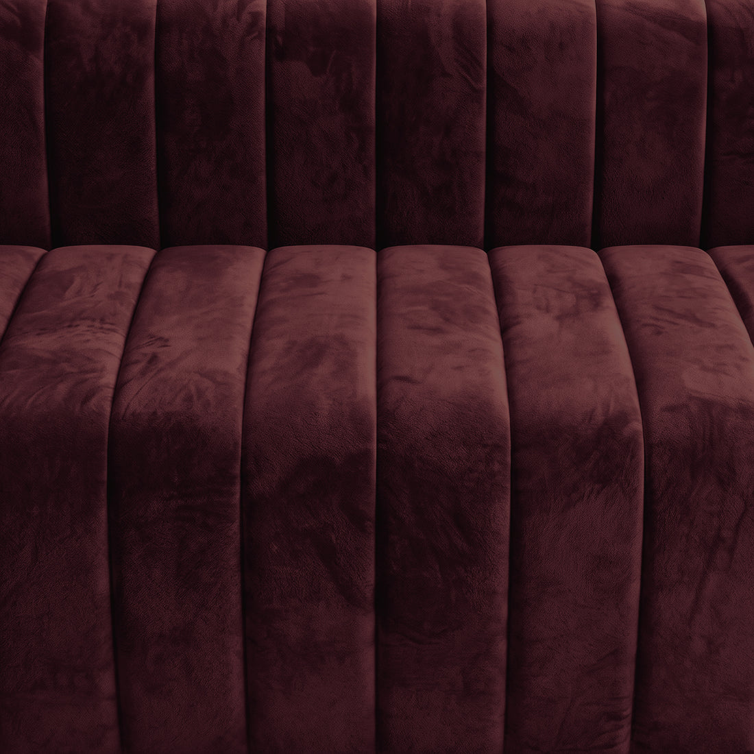 Close-up of burgundy upholstered furniture fabric and tufting
