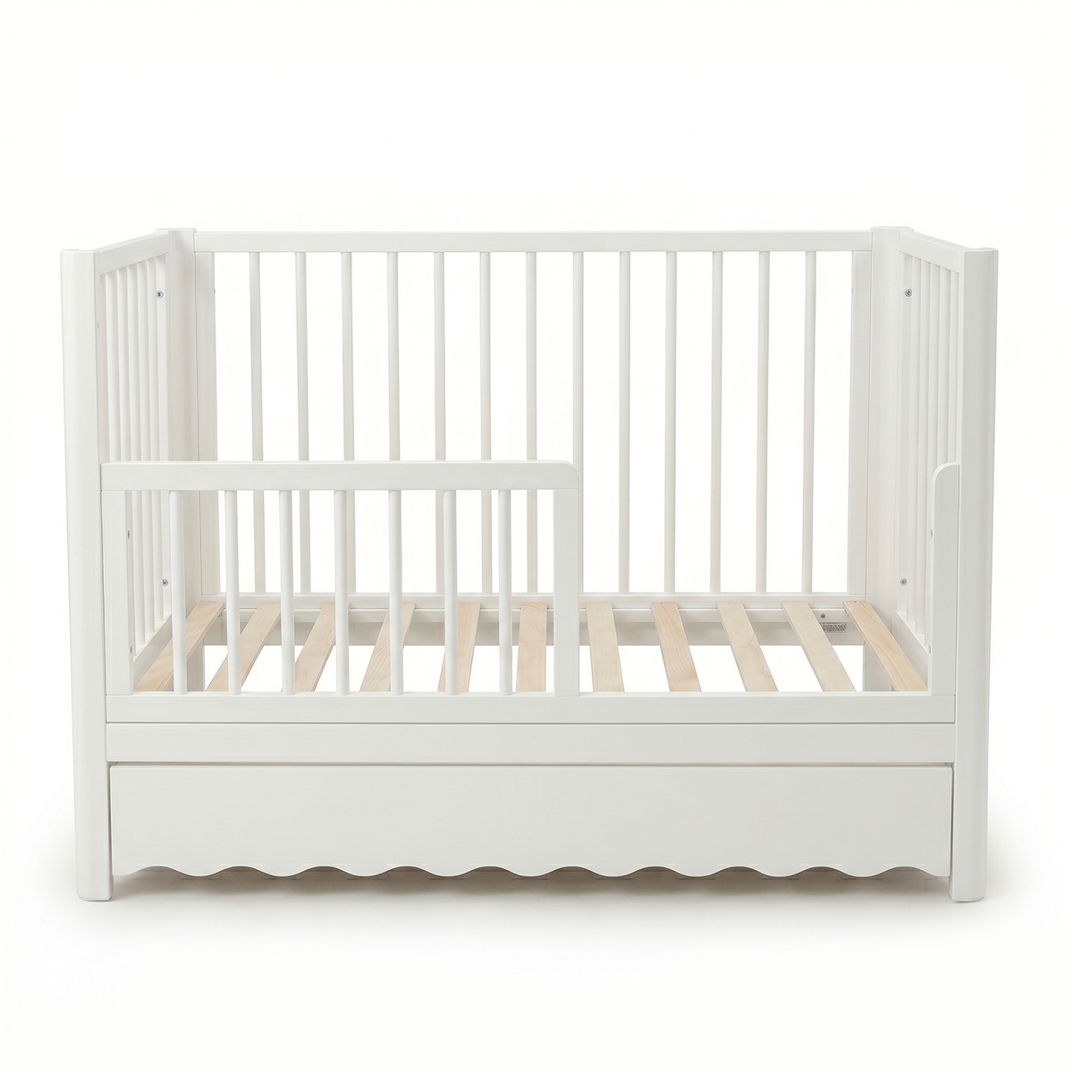 White toddler crib with underbed drawer on white background