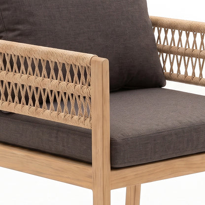 Close-up of chair arm and seat with woven detail and dark cushion