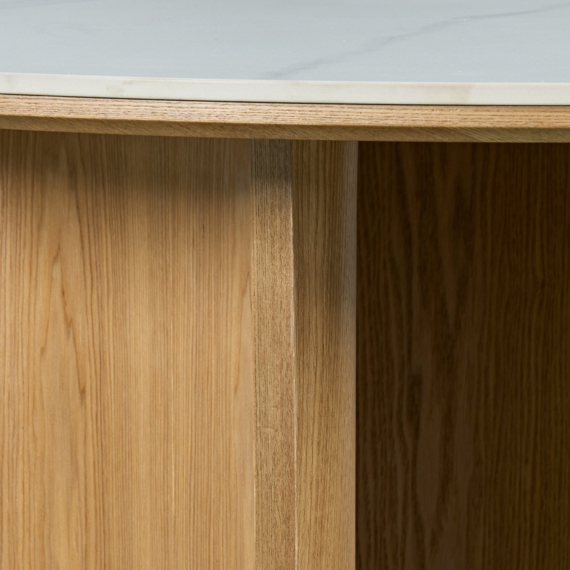 Close-up of table edge and wooden base with marble-like top