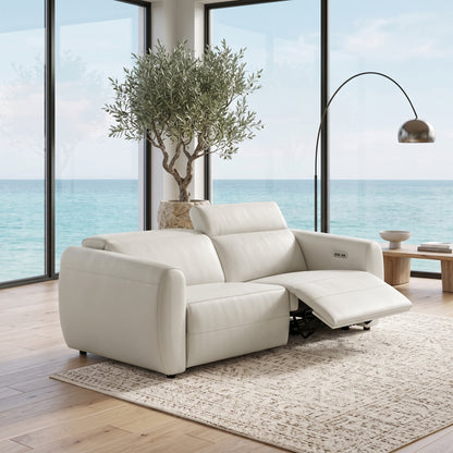 Light-colored two-seat recliner sofa in a coastal living room with ocean view