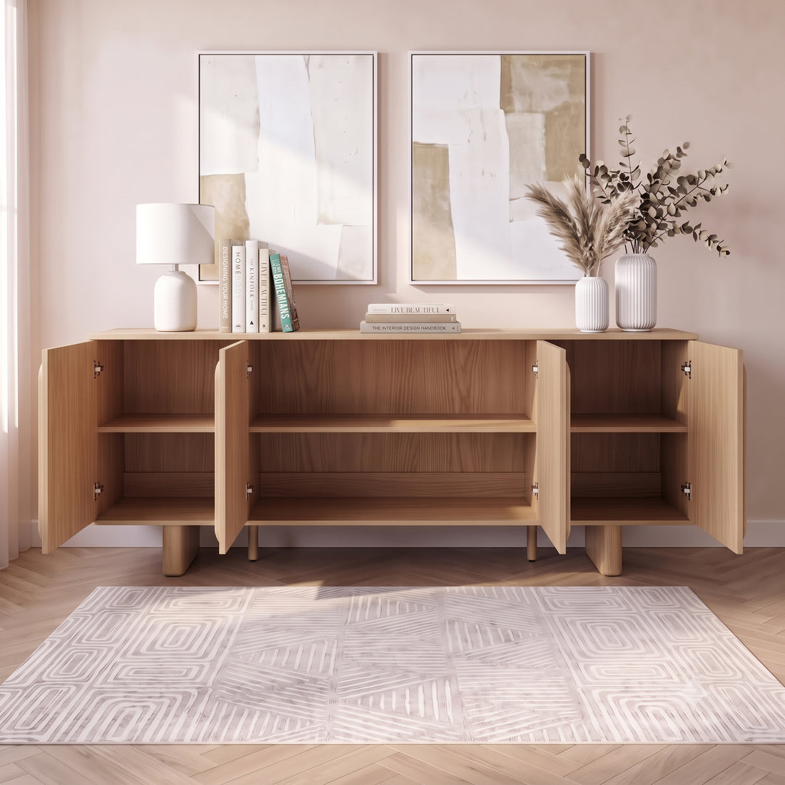 Wooden sideboard in a styled room with open cabinet doors, rug, lamp, and wall art
