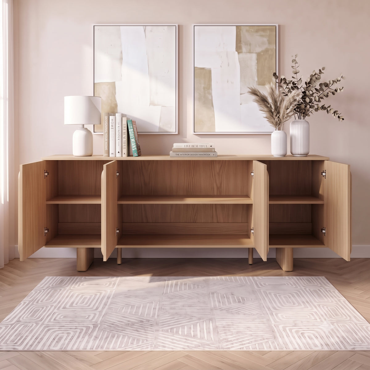 Wooden sideboard in a styled room with open cabinet doors, rug, lamp, and wall art