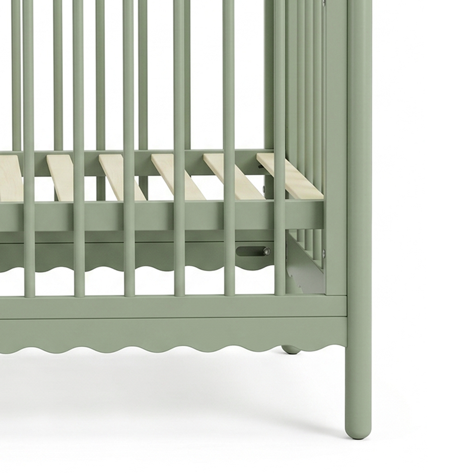 Close-up of the lower slats of a sage green crib
