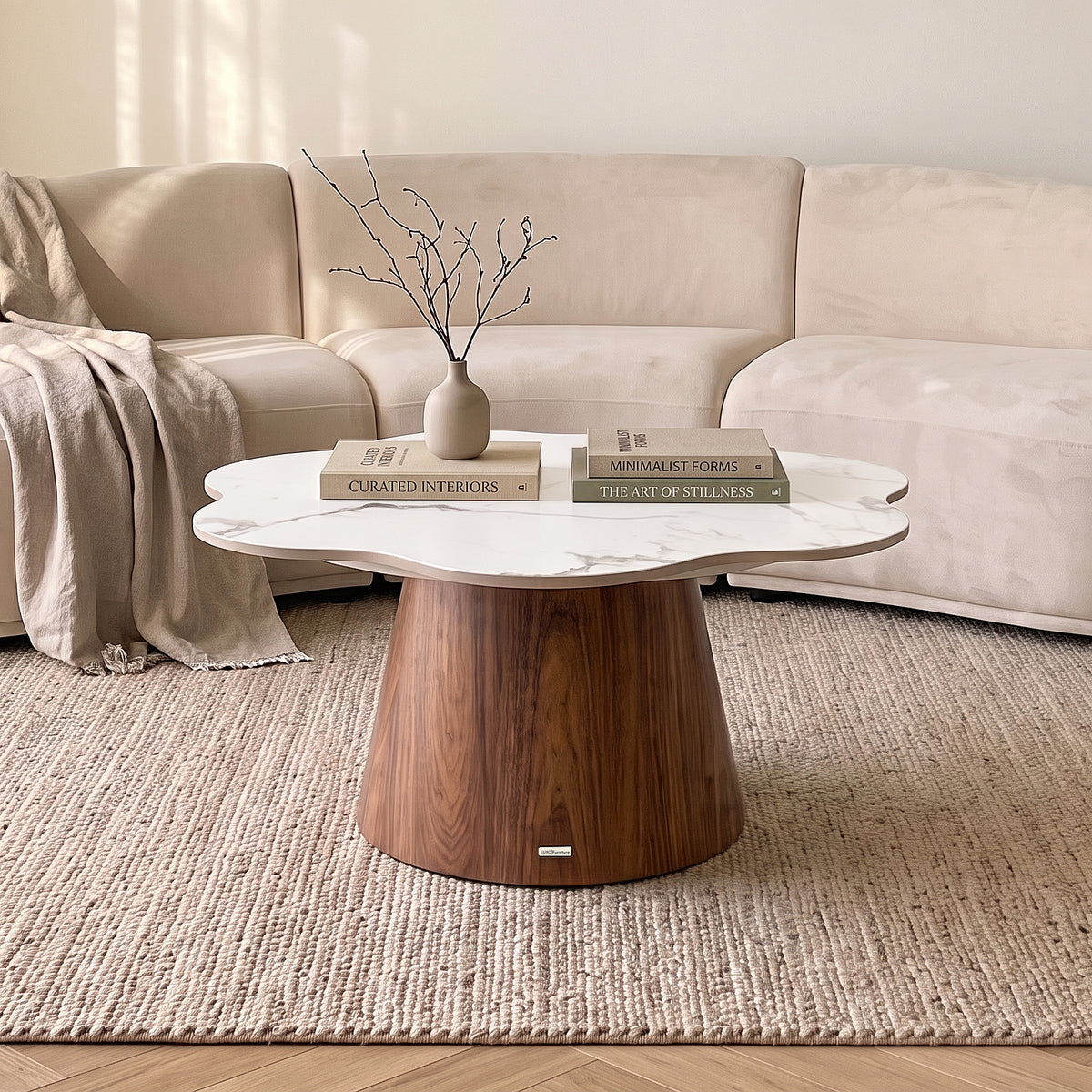 Coffee table styled in a cozy living room with books and a vase