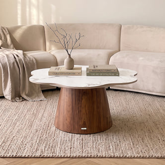 Coffee table styled in a cozy living room with books and a vase