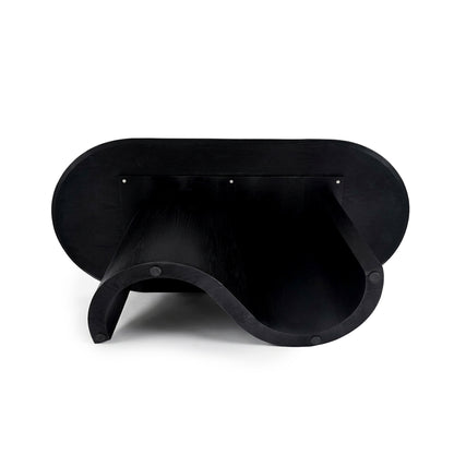 Full view of a sculptural black furniture piece with a wavy silhouette on a white background