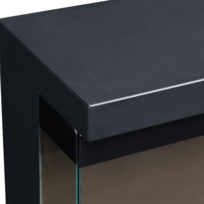Detail shot of top front corner of electric fireplace on white background, showing black metal frame and glass.