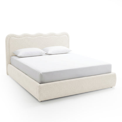 Modern upholstered bed with wavy headboard on white background