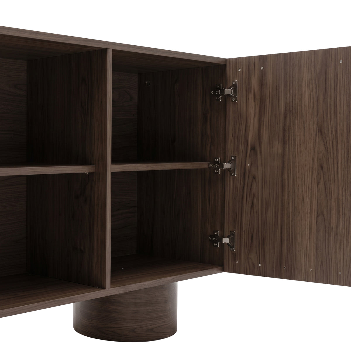 Partial view of wooden sideboard interior shelving with one open door on a white background