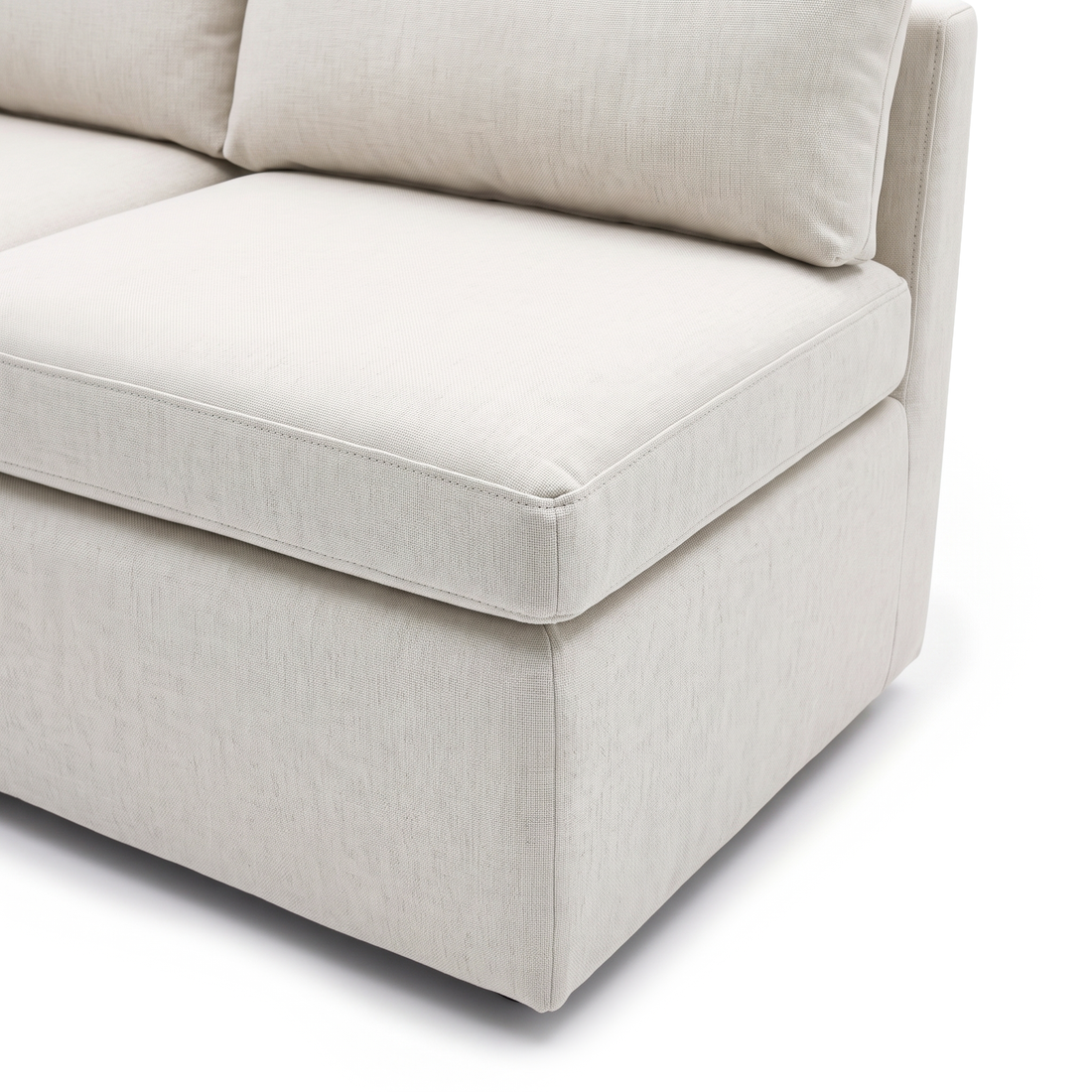 Close-up of cream sofa upholstery, cushion, stitching, and side panel