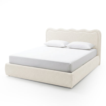 Off-white upholstered king bed with wavy headboard on white background