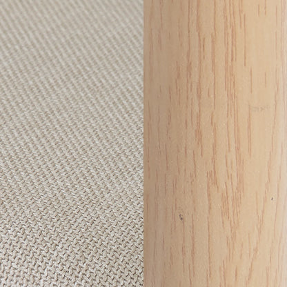 Close-up of beige upholstery and wooden chair frame detail.