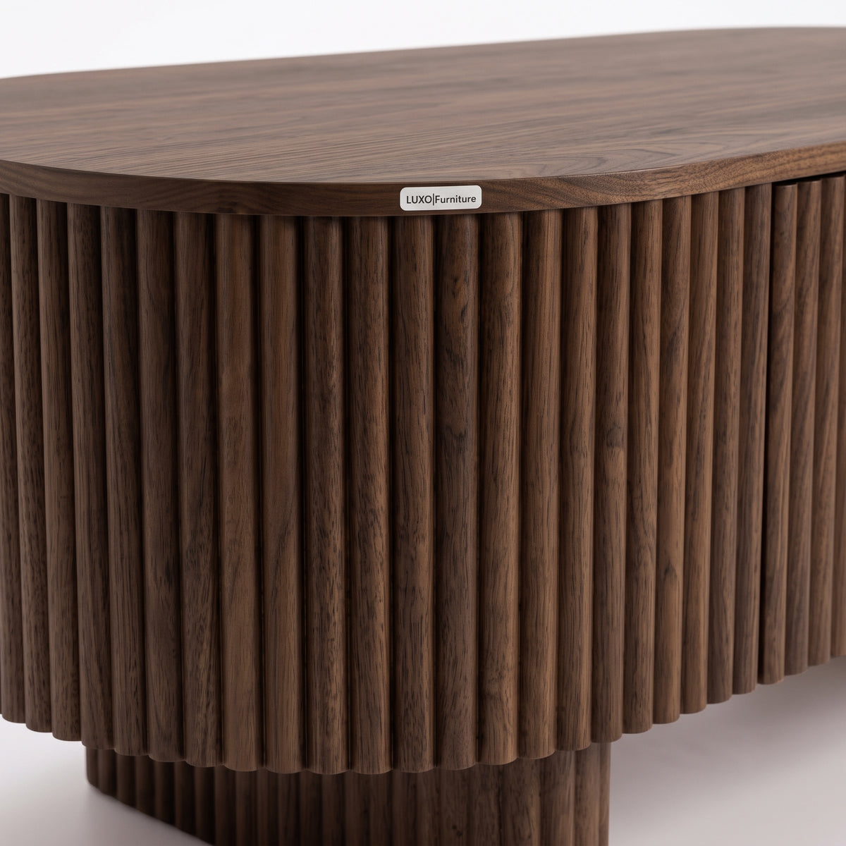 Close-up of a dark wood table edge with vertical ridged detailing on a white background