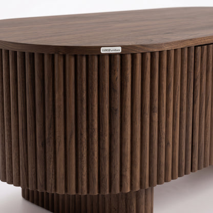 Close-up of a dark wood table edge with vertical ridged detailing on a white background