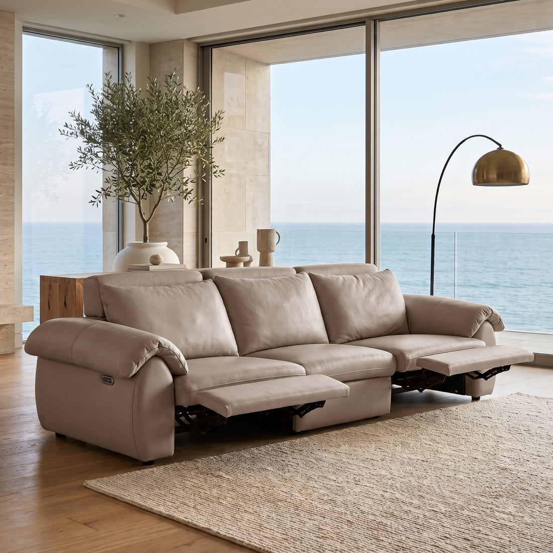 Three-seater reclining sofa in a modern living room with ocean view