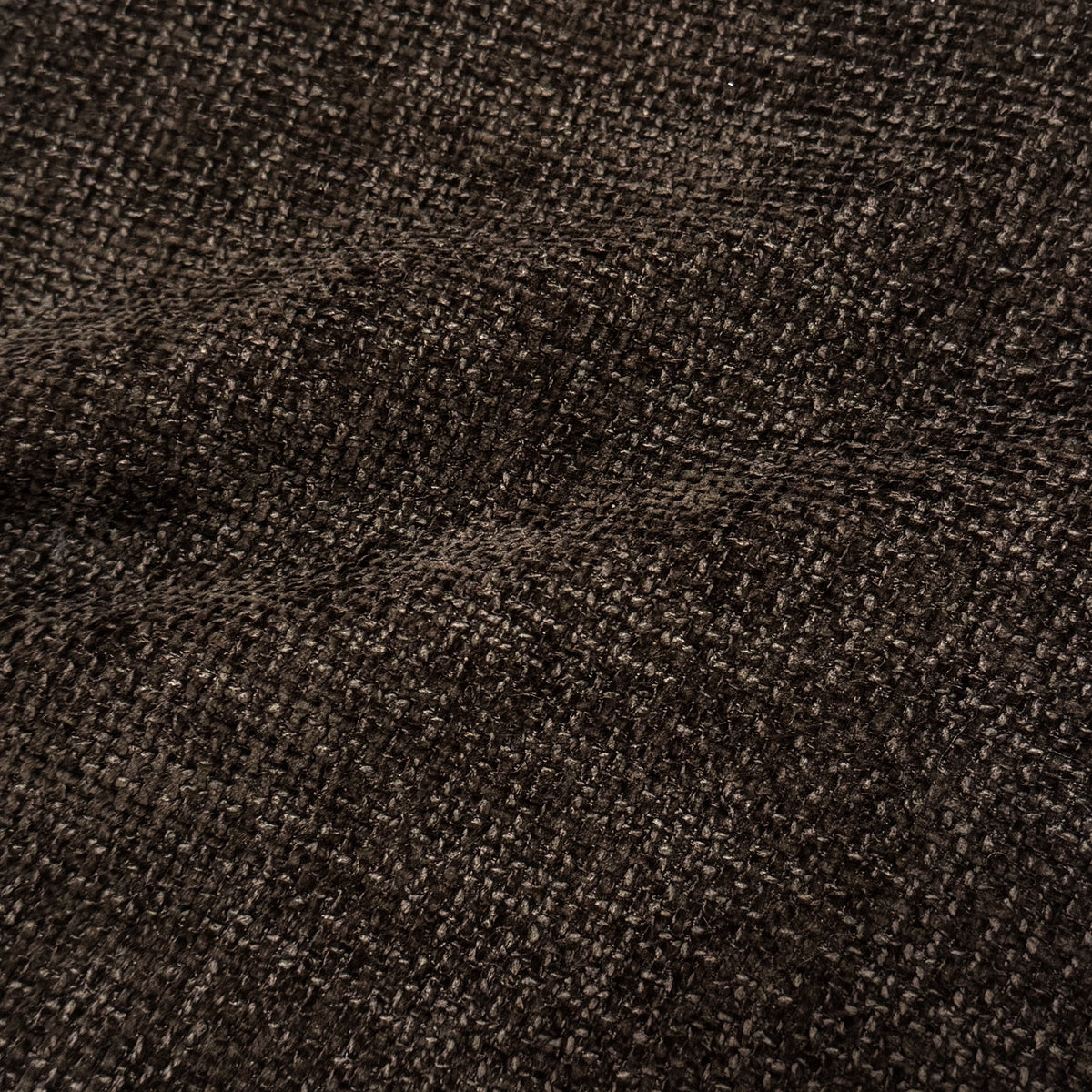 Close-up of cocoa brown woven upholstery fabric texture.