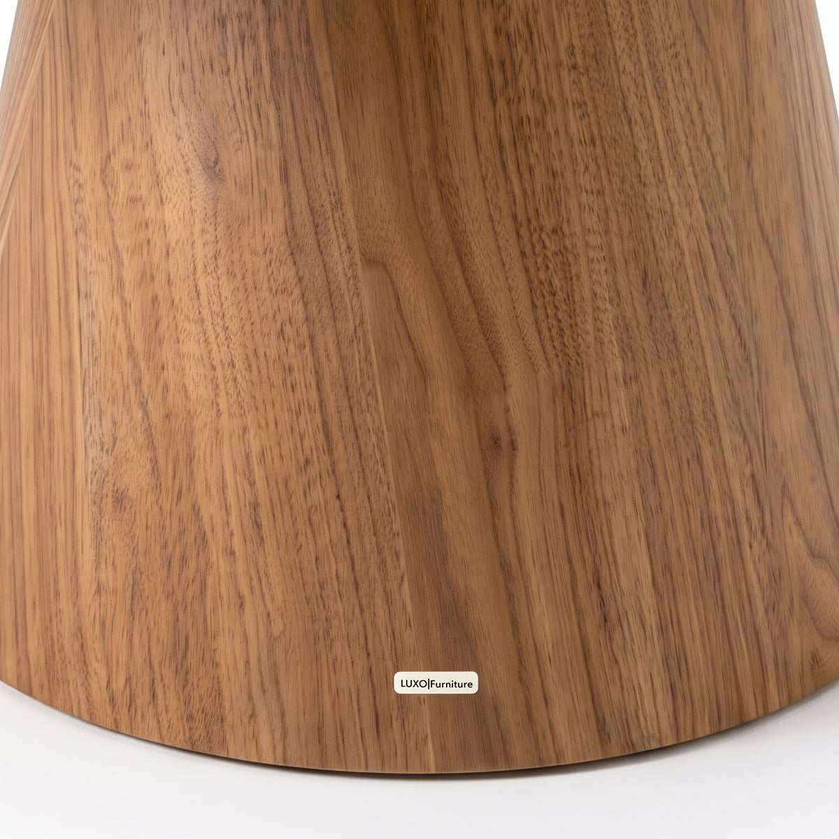 Close-up of the lower section of a wooden furniture base on a white background