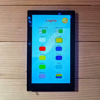 Touchscreen lighting control panel mounted on a wooden wall